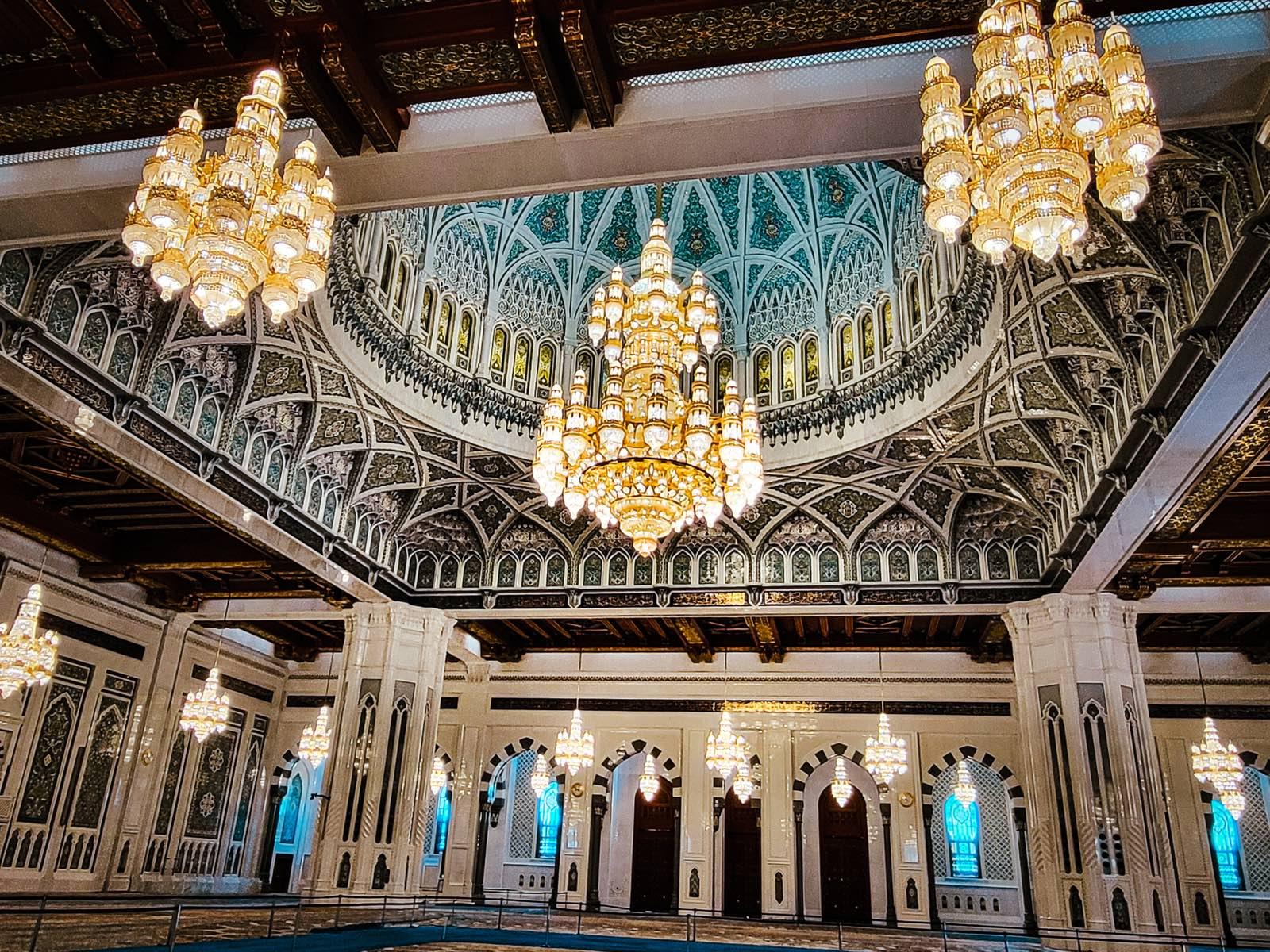 The prayer hall of the Sultan Qaboos Grand Mosque, with dome and chandeliers