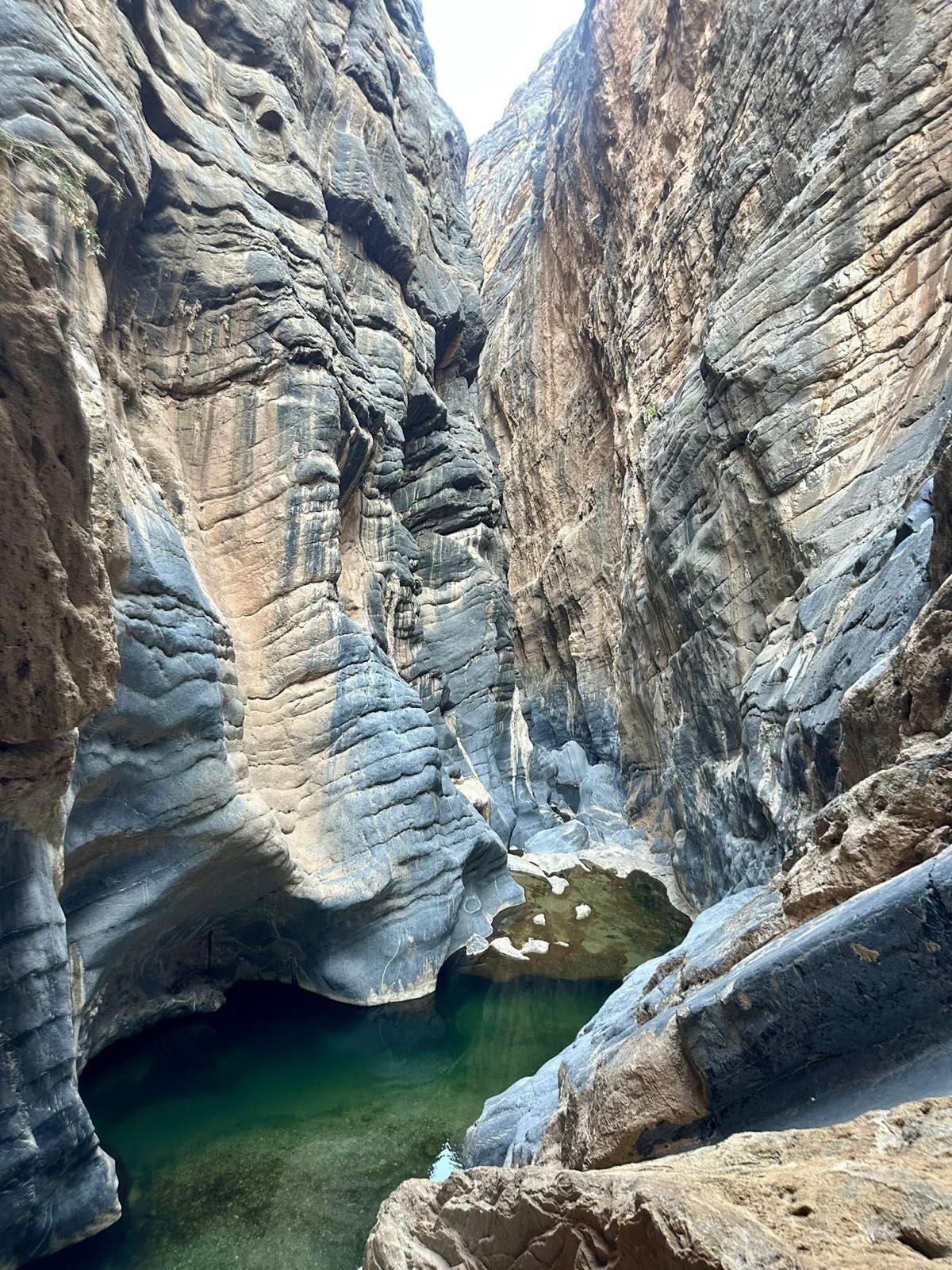At the end, a natural pool awaits between smooth rock walls