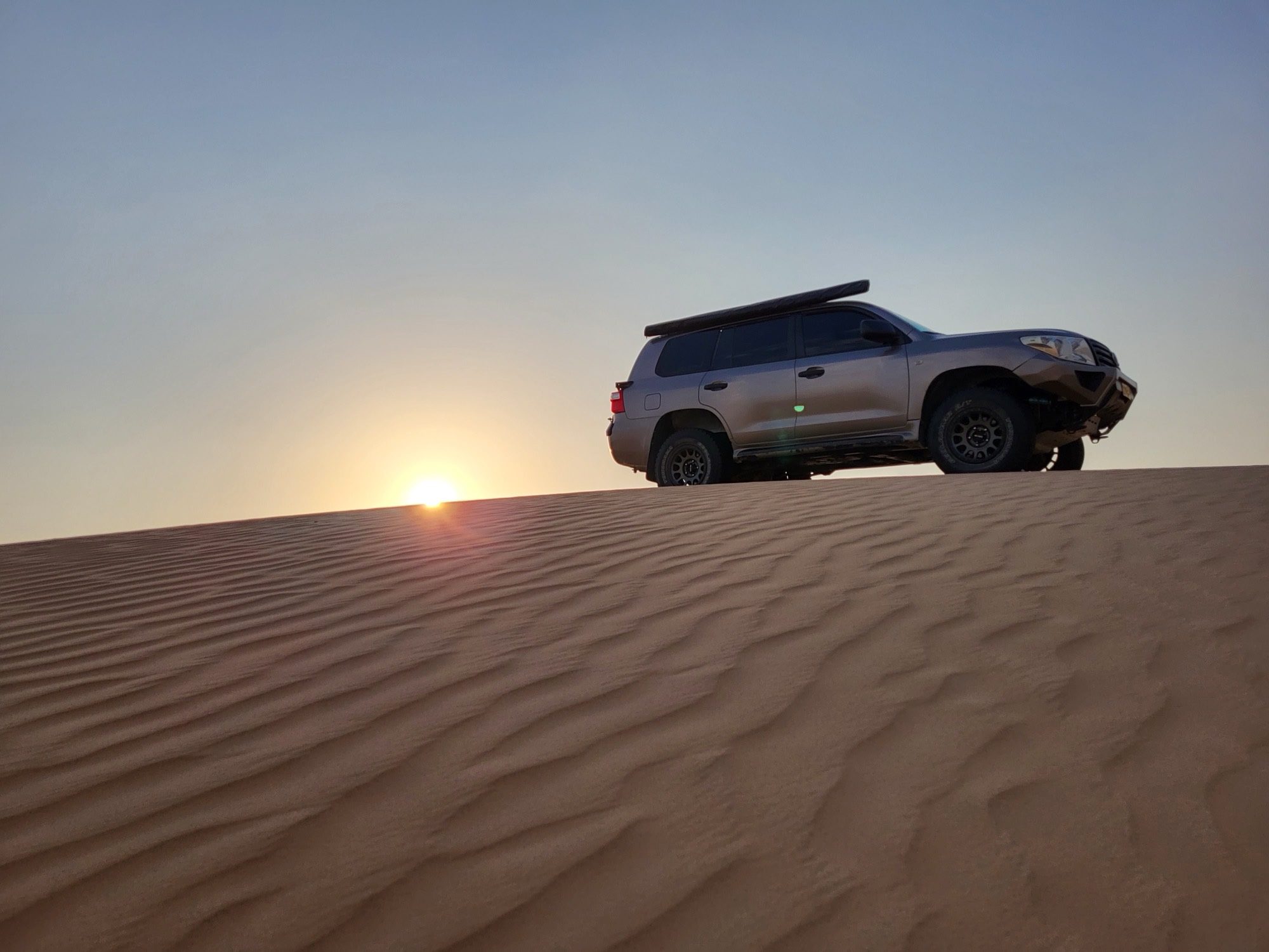 Cresting the dunes in a 4x4 just before sunset