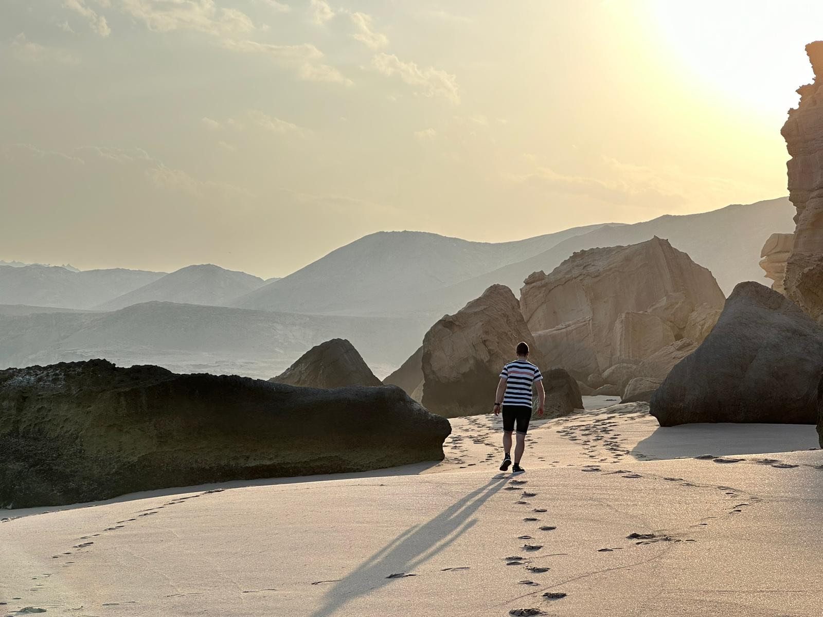 A quiet beach walk at sunset on the Omani coast